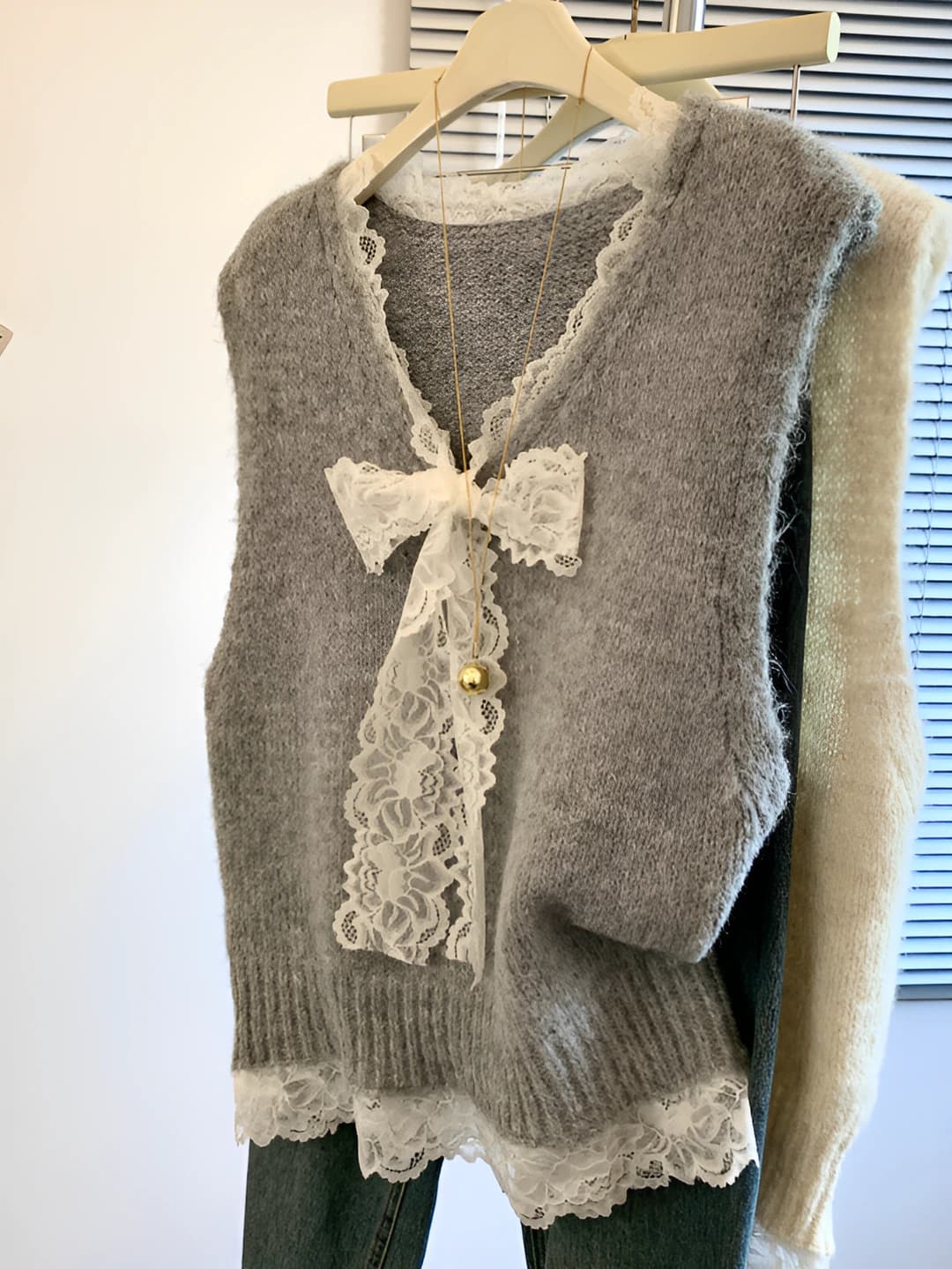 Women's knitted sweater vest with V-neck, lace and bow pattern, sleeveless, 2026