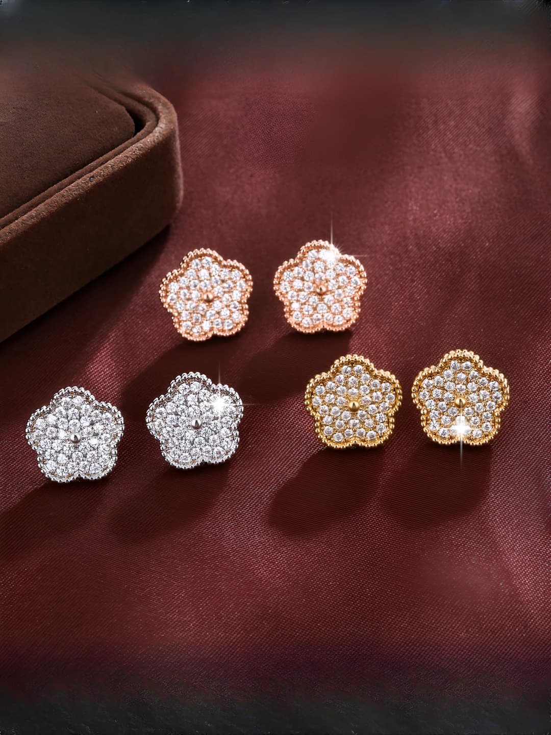 Women's flower design element stud earrings with zircon and colored metal in light luxury style