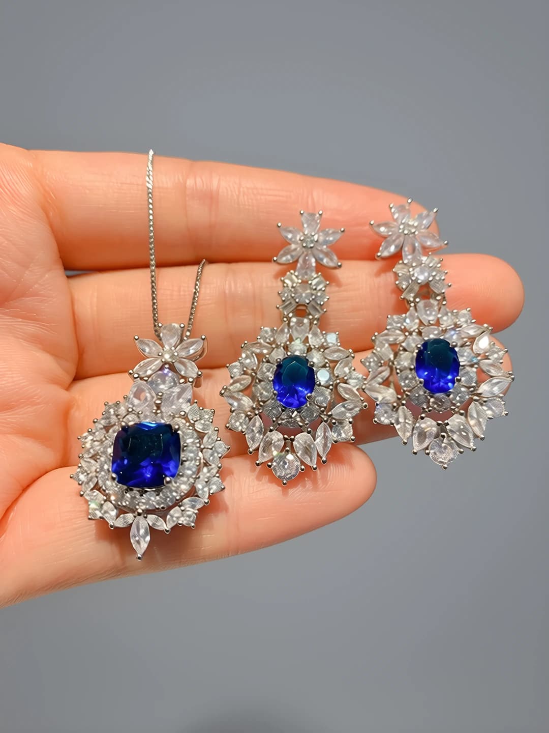 Women's gold-plated brass jewelry set with blue synthetic spinel and geometric pattern (earrings and pendant)