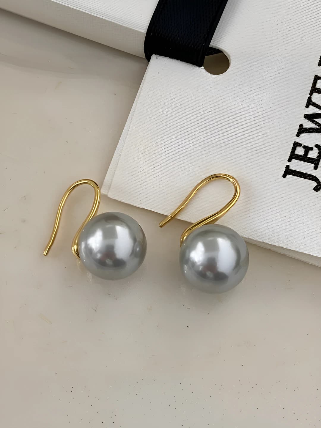 Gold earrings with 12mm grey glass pearls