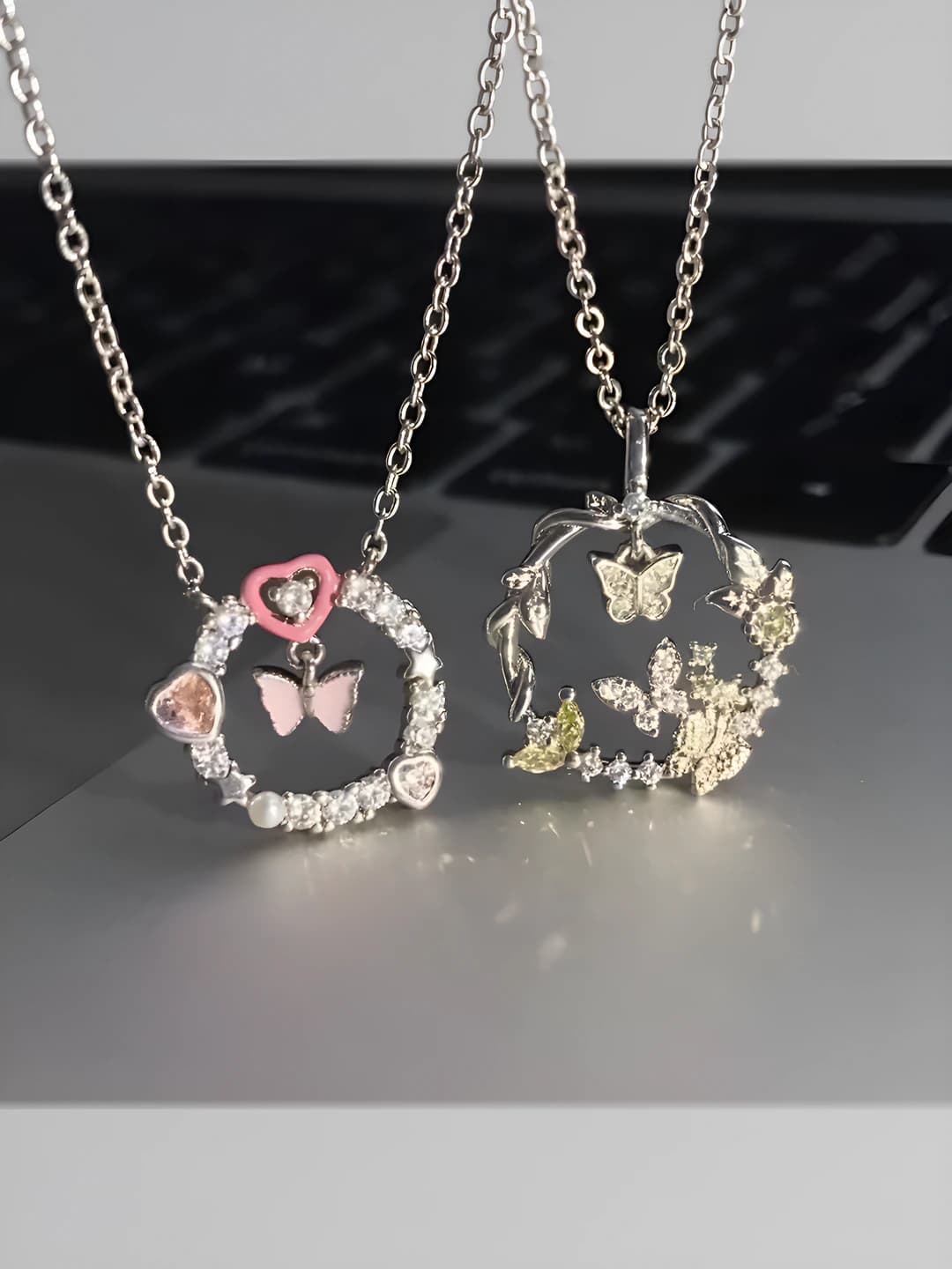Women's set of two necklaces with butterfly and thorn ring pendants