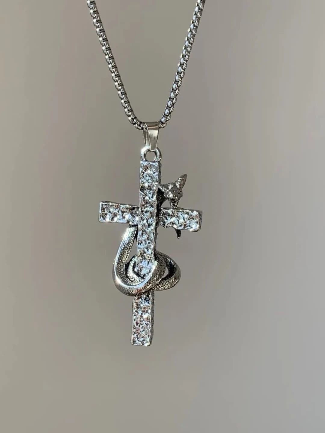 Snake wrapped cross necklace