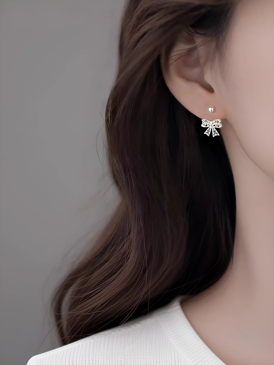 Women's bow-shaped stud earrings with silver post and screw back