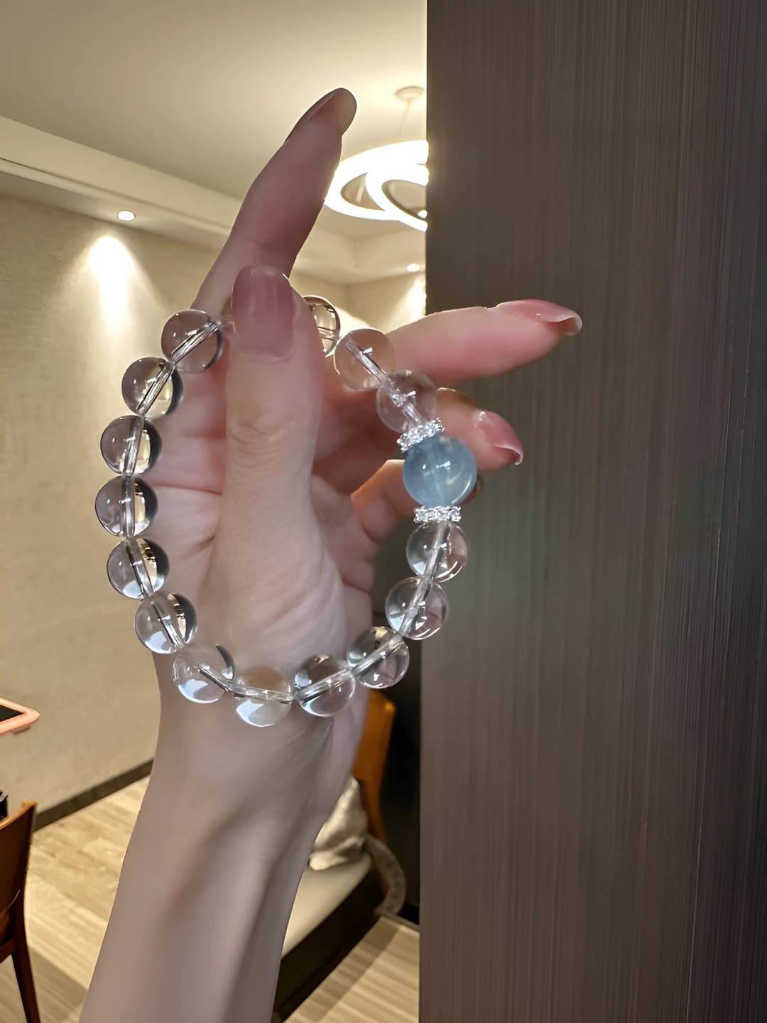 Women's bracelet with 18 natural white crystal beads 12 mm and a single aquamarine bead bracelet