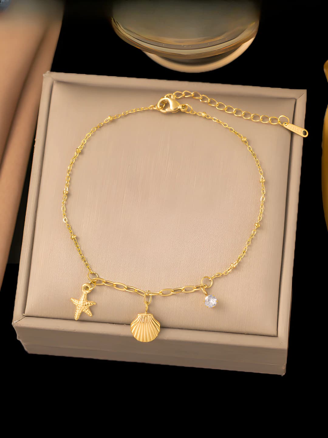 Star and shell bracelet, gold