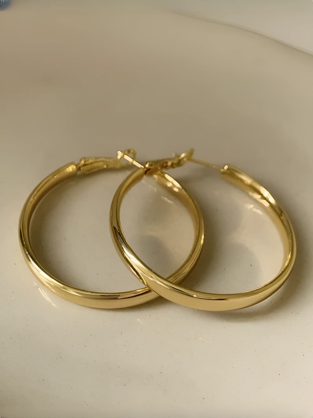 Women's round metal hoop earrings, unique and modern design