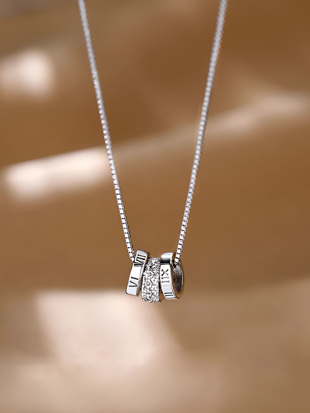 Women's simple necklace with Roman numerals and three rings design element