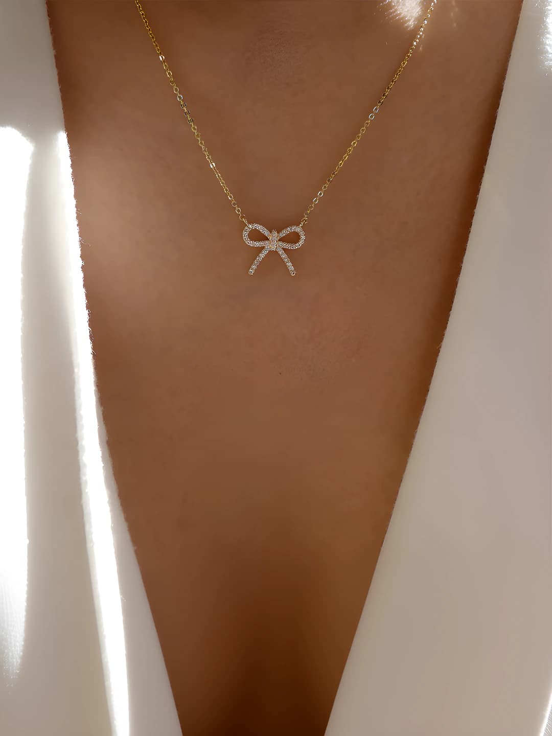Gold diamond bow necklace