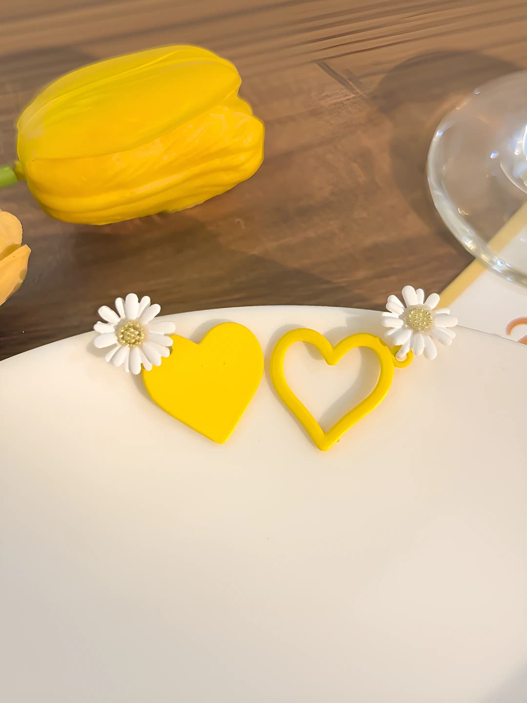 Asymmetric yellow heart stud earrings