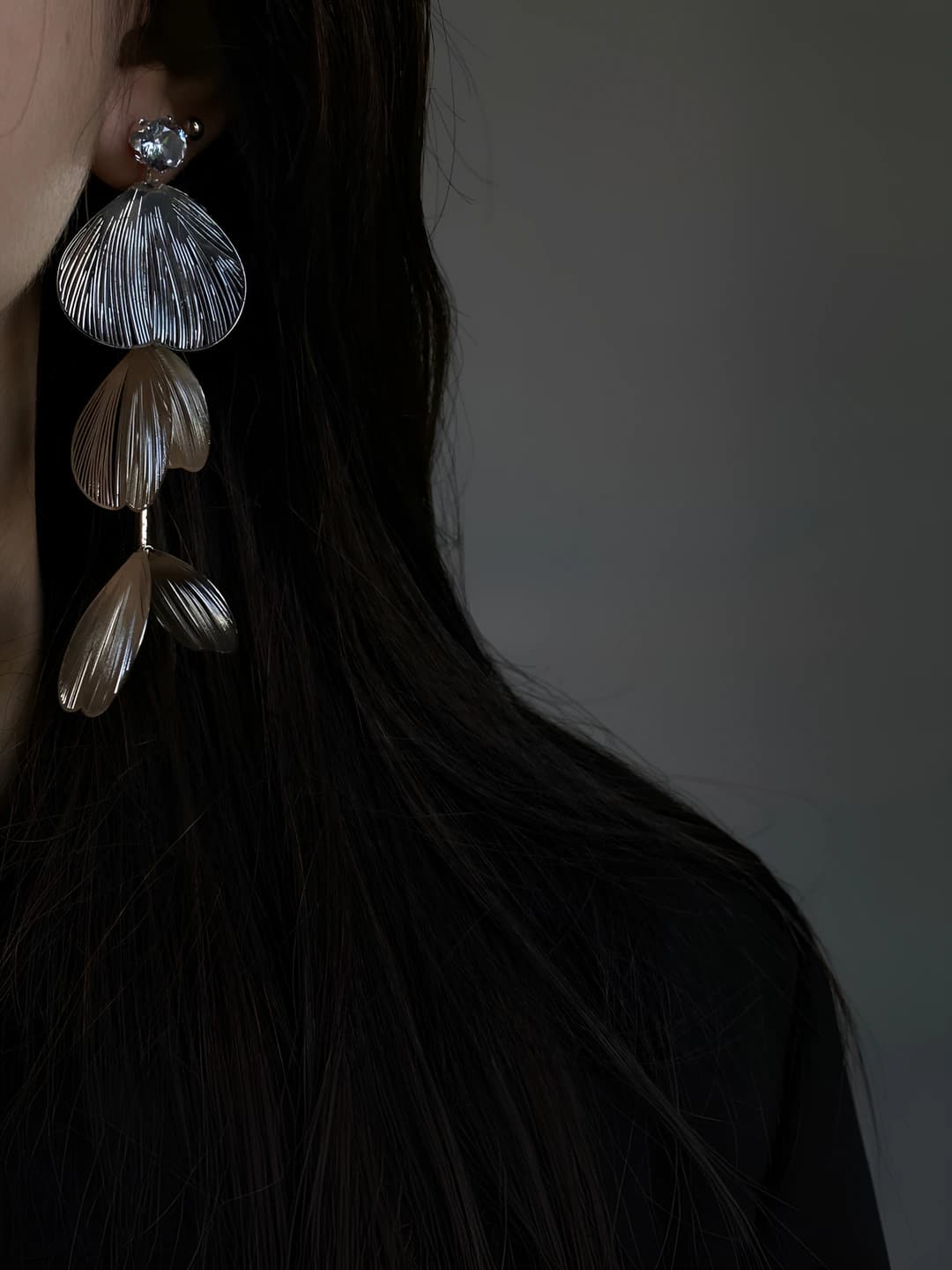 Women's long silver flower-shaped earrings with tassels