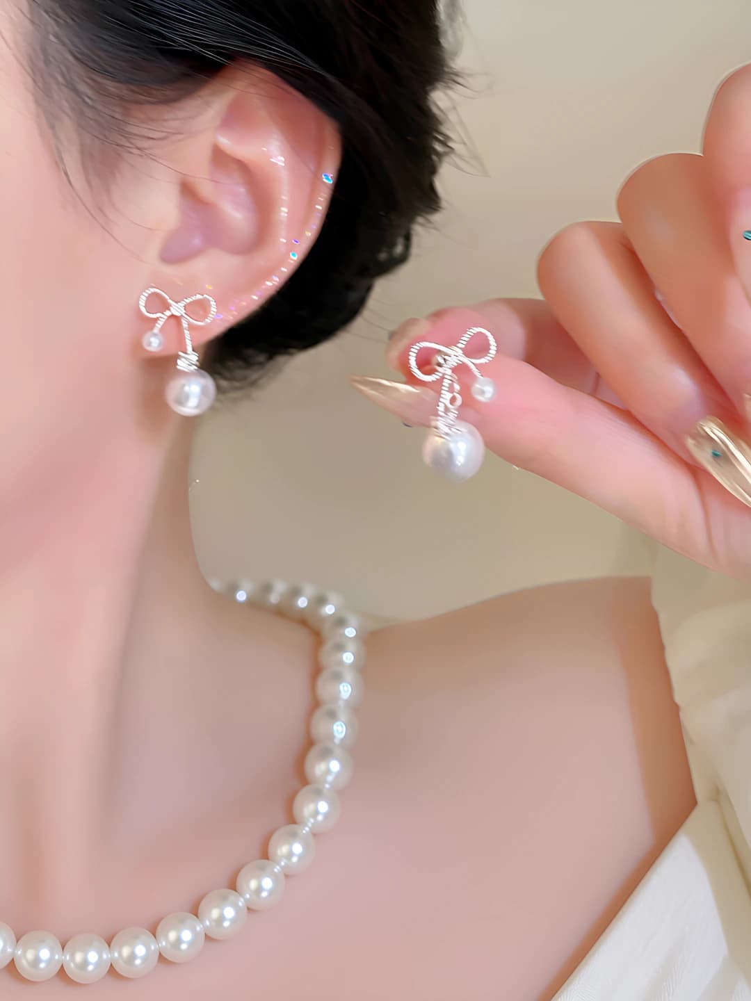 Silver bow pearl stud earrings