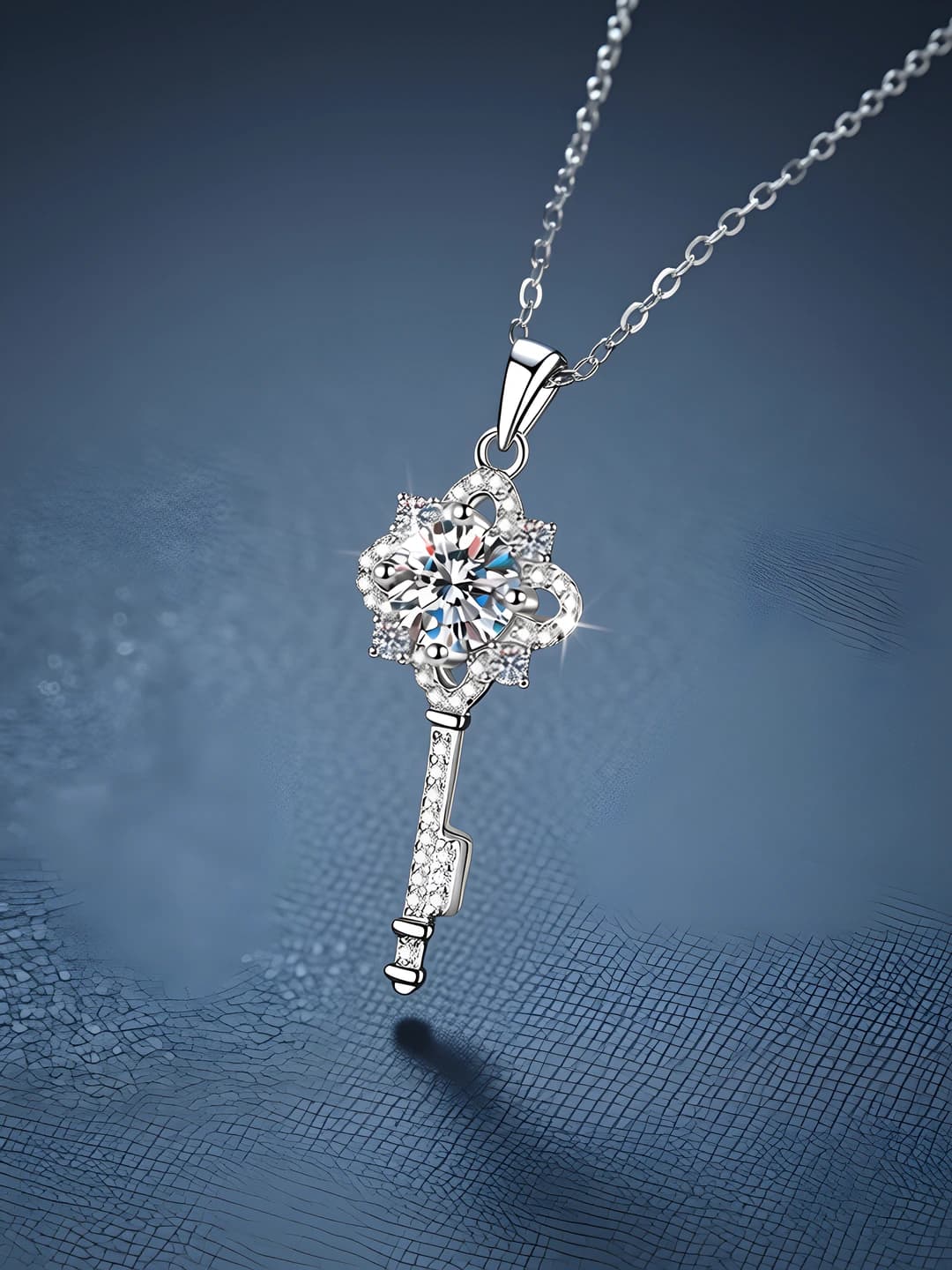 Women's silver chain necklace with moissanite pendant: crown, floral, leaf and bow design elements