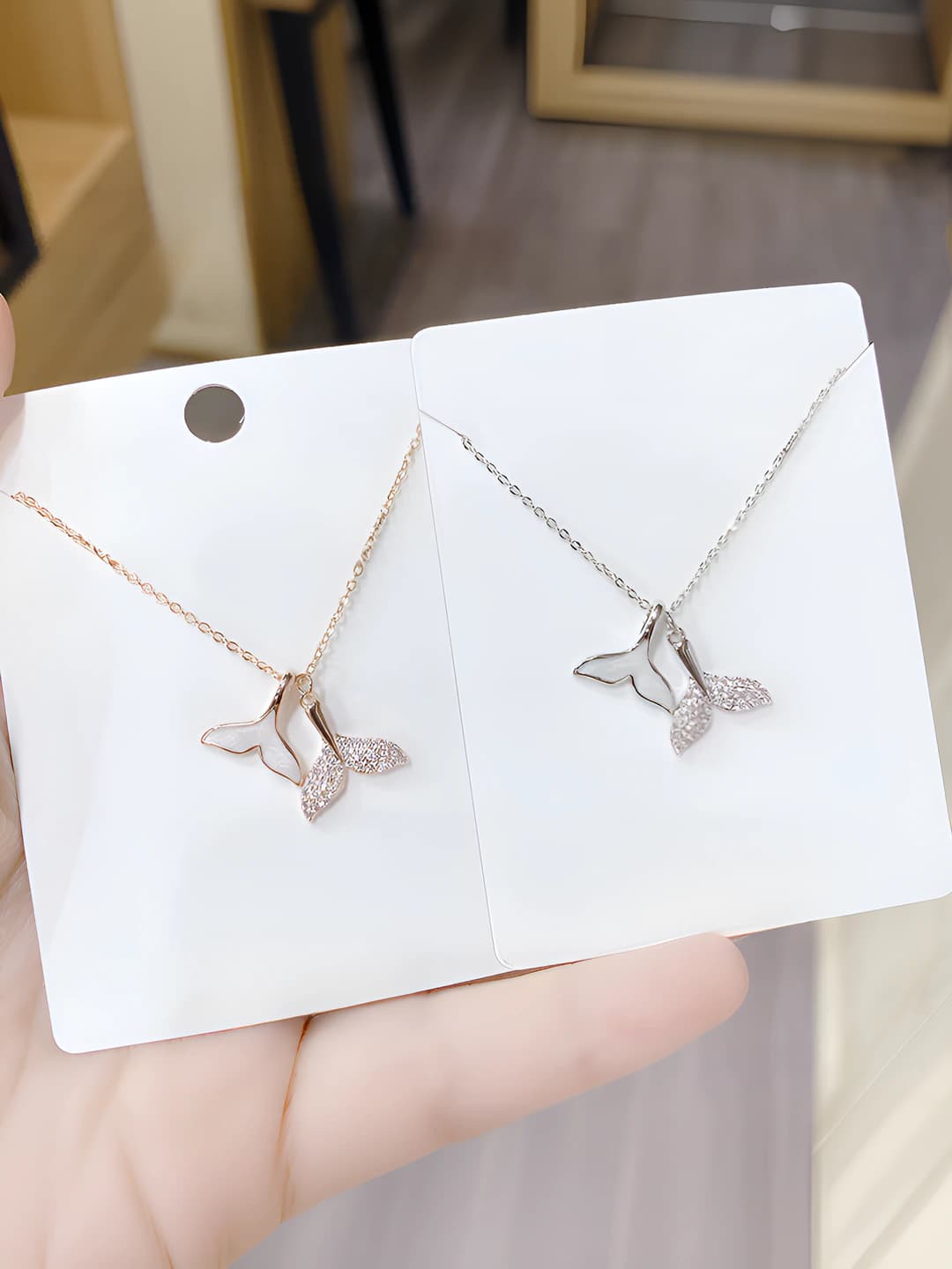 Women's mermaid tail pendant necklace, fully pavé with diamonds, featuring a dolphin and fish tail design