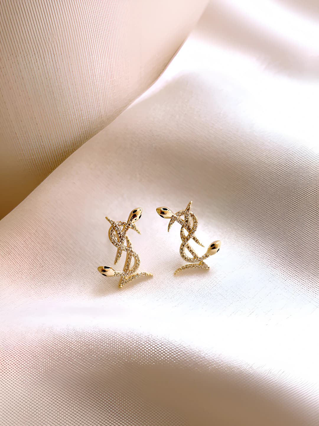 Women's gold-tone alloy stud earrings with crystals and letters in snake shape