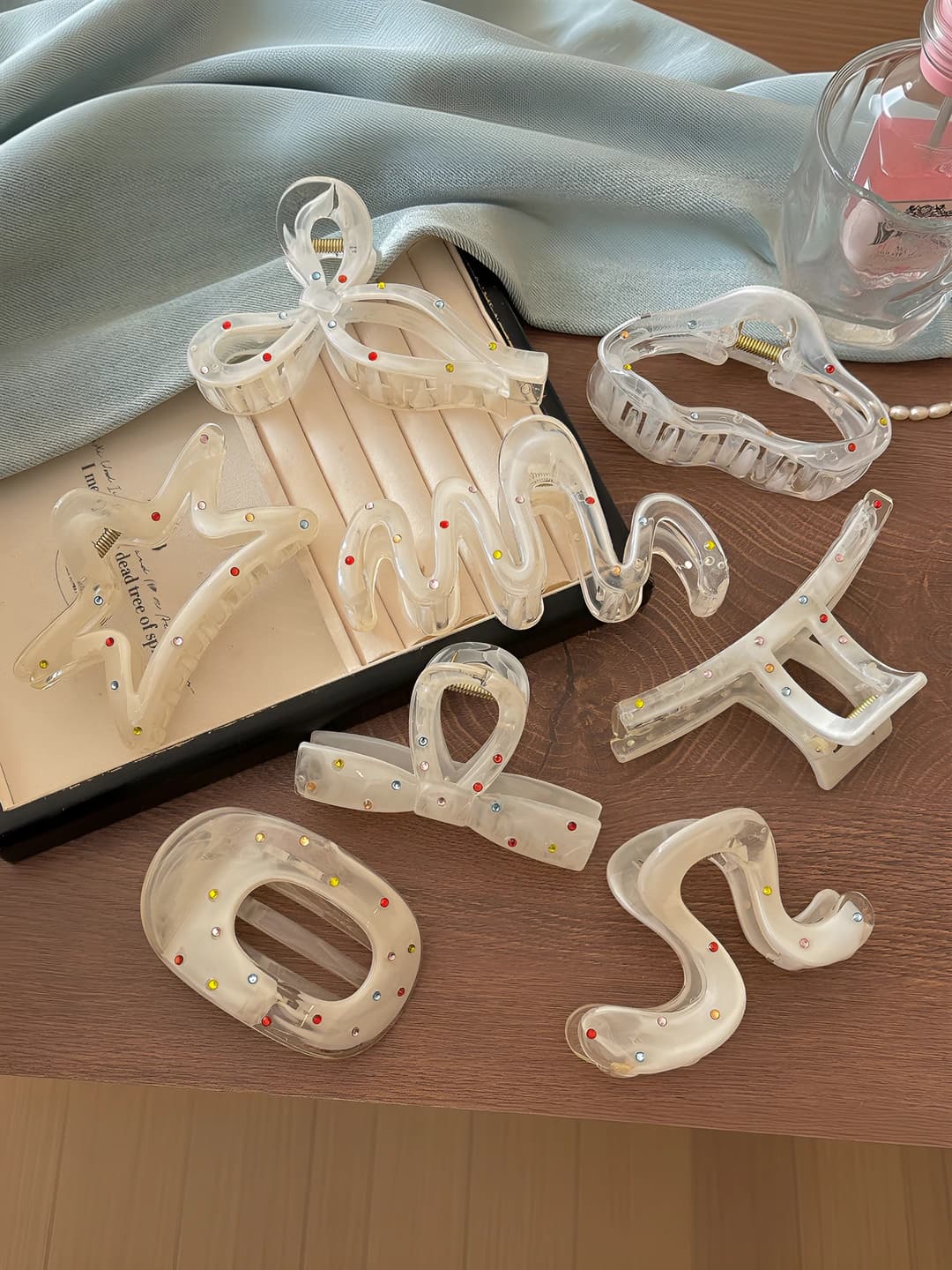Women's hair clips and combs: white acrylic claw clip with colorful rhinestones and bow design