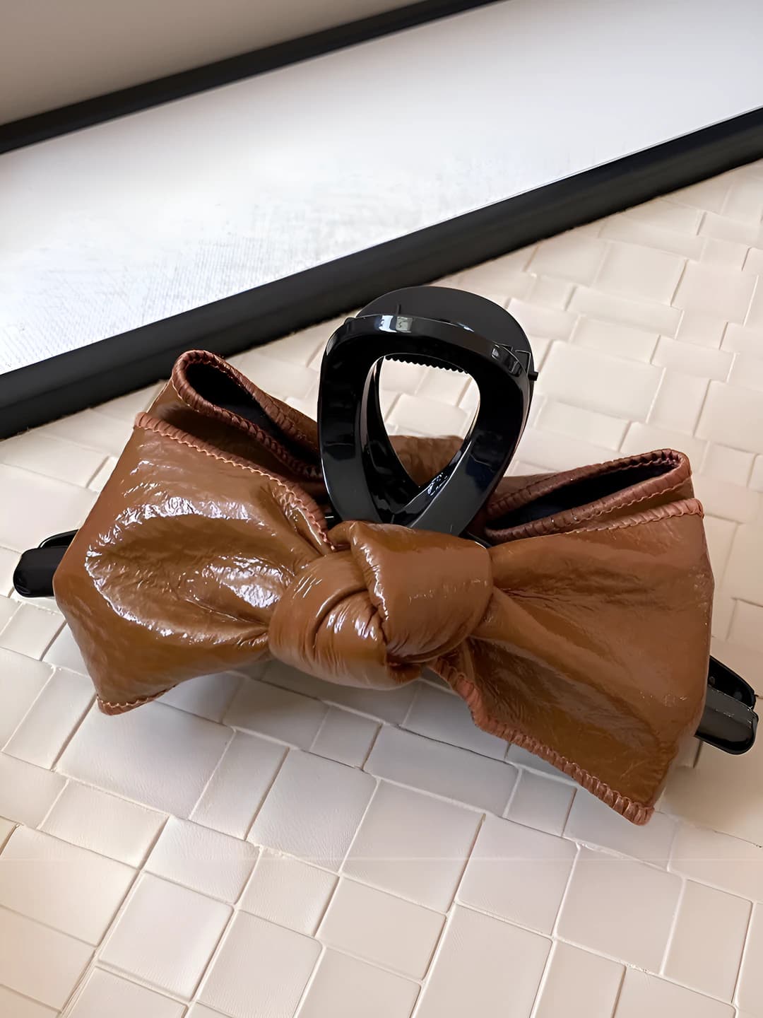 Brown leather bow