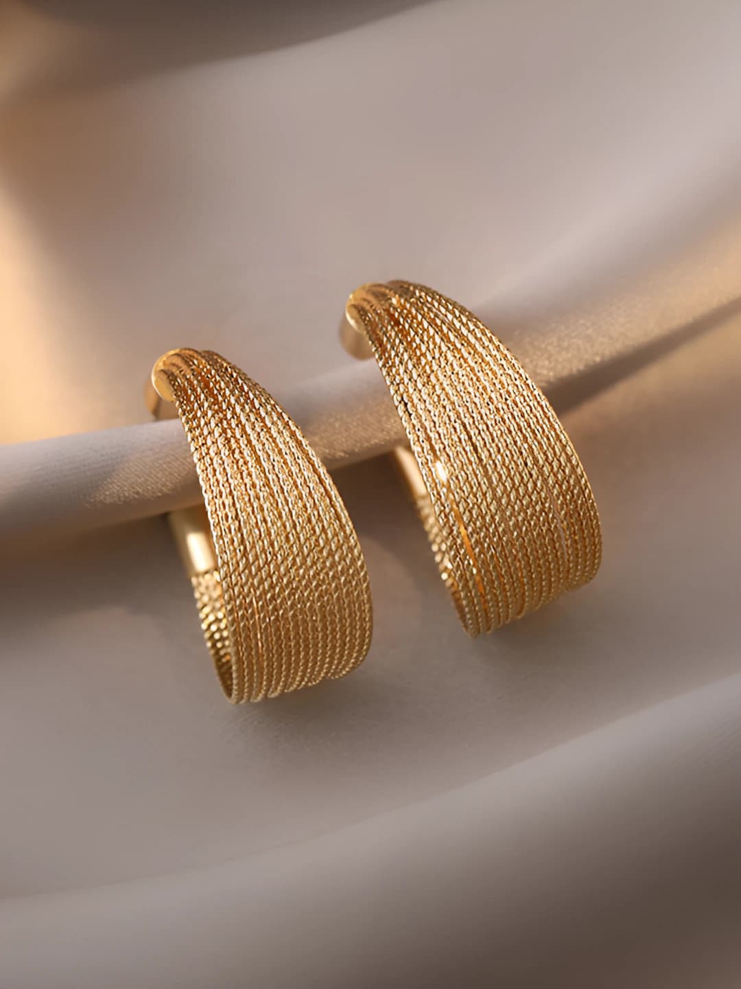 Women's copper hoop earrings with geometric design in minimalist style