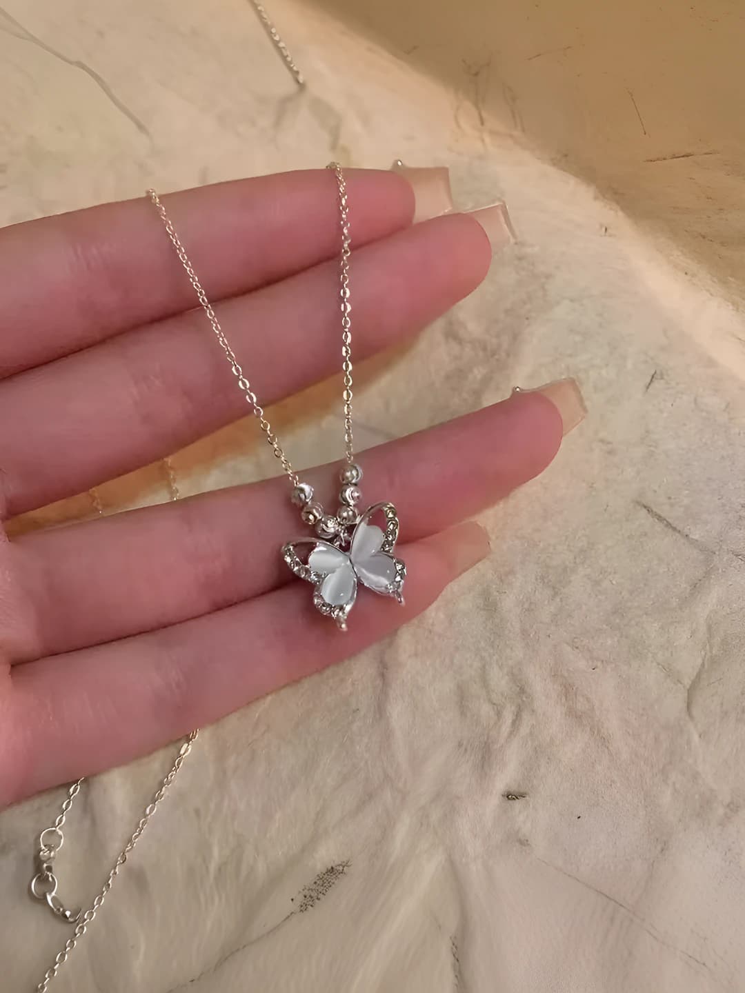 Women's butterfly pendant necklace: cat's eye stone, icy, with skirt