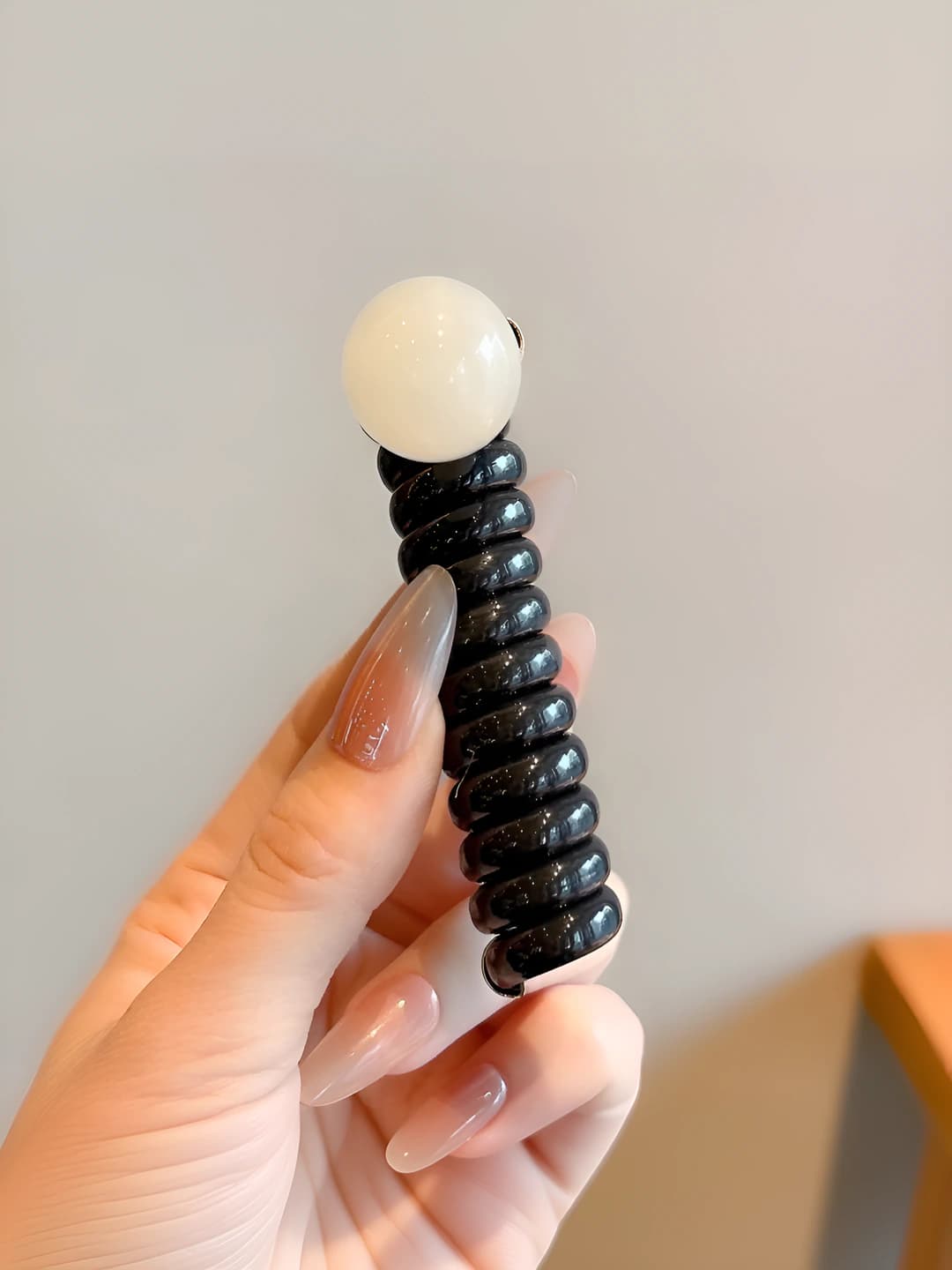 Brown, telephone cord, off-white pearls