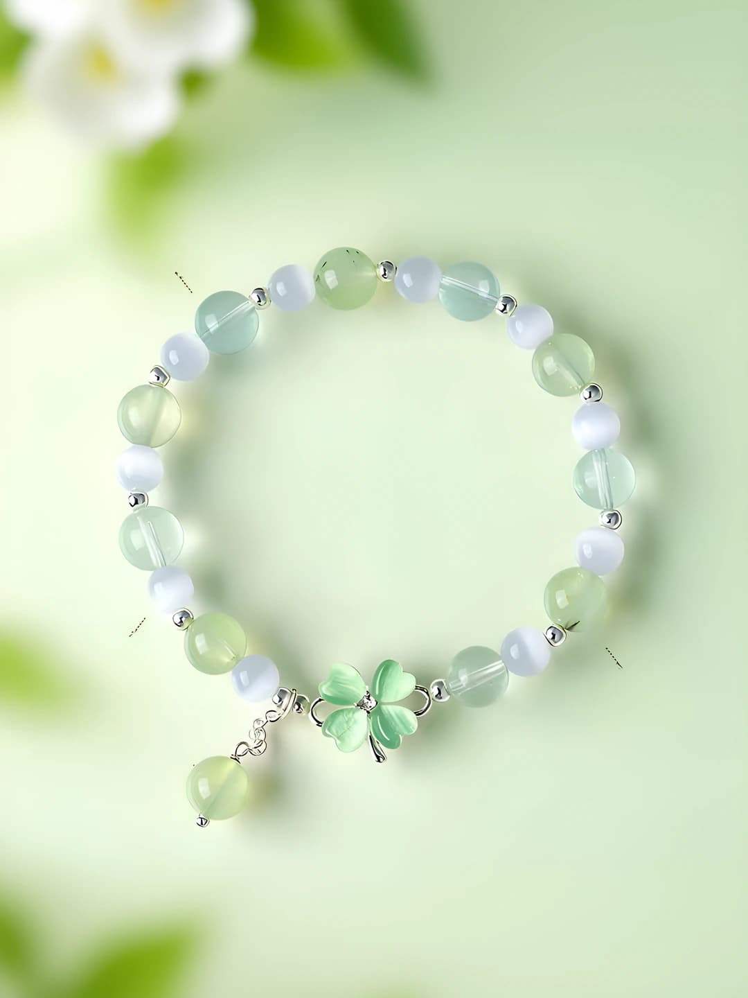 Women's beaded bracelet with natural rose quartz and cat's eye featuring a lucky clover design