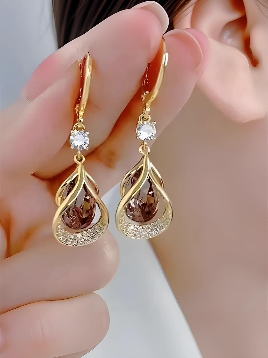Women's dangle earrings with purple crystals in a teardrop and geometric design