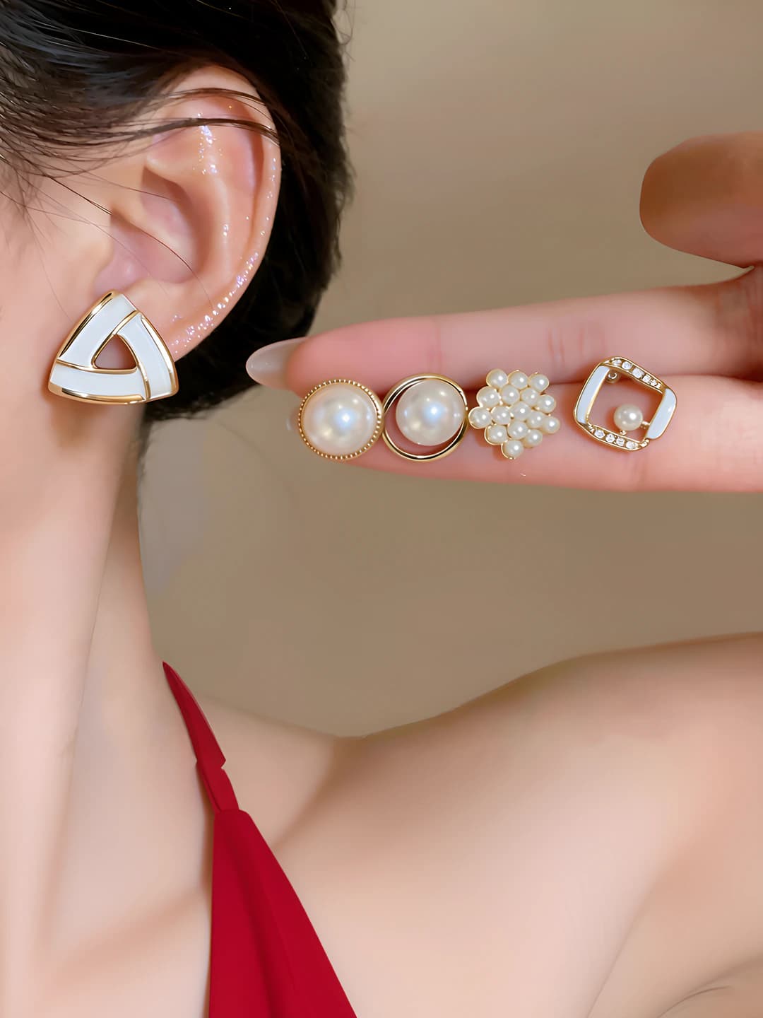 Women's set of geometric pearl stud earrings with crystals, circular and triangular design elements, French style, steel posts