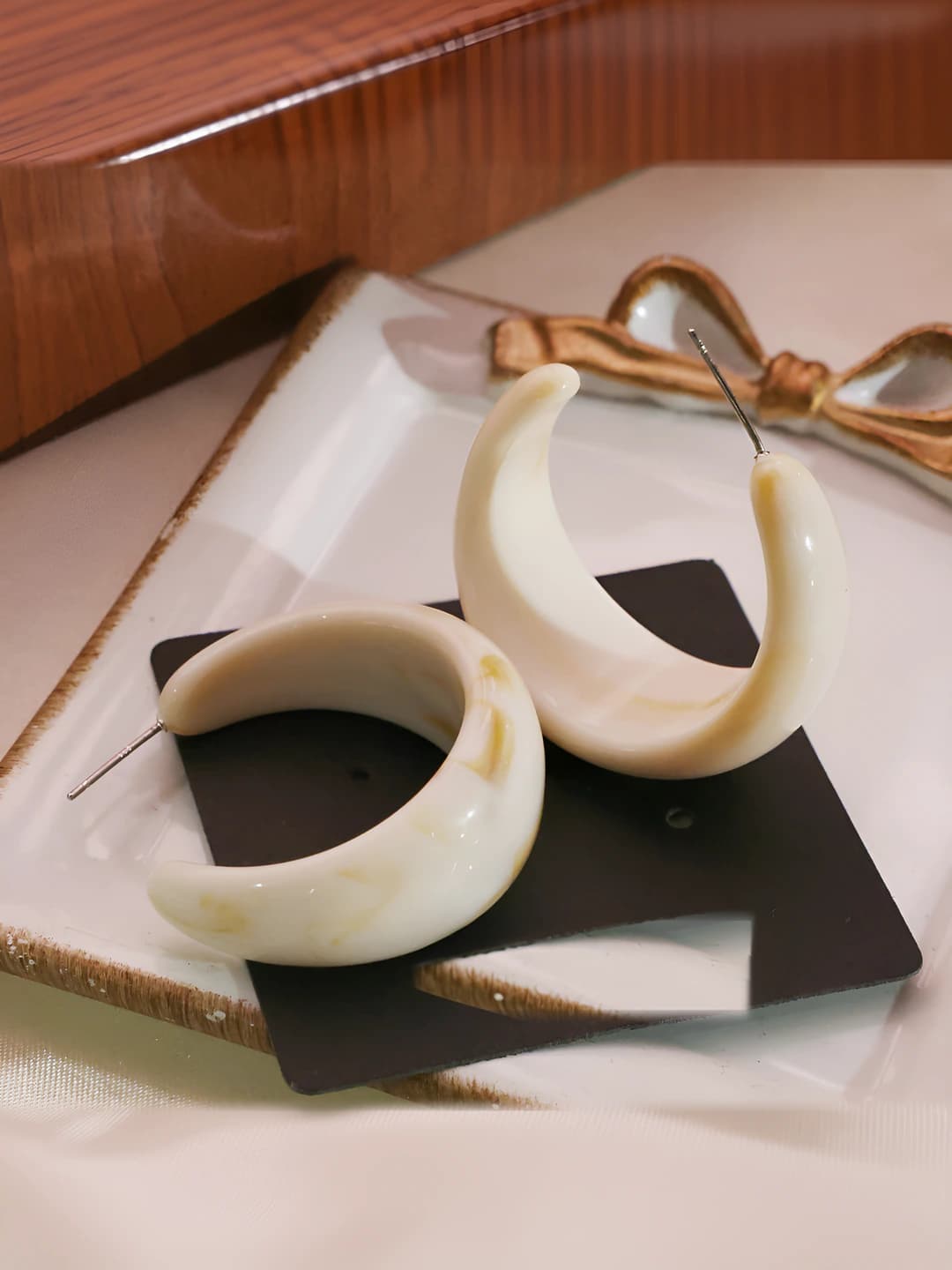 Beige C-shaped studs