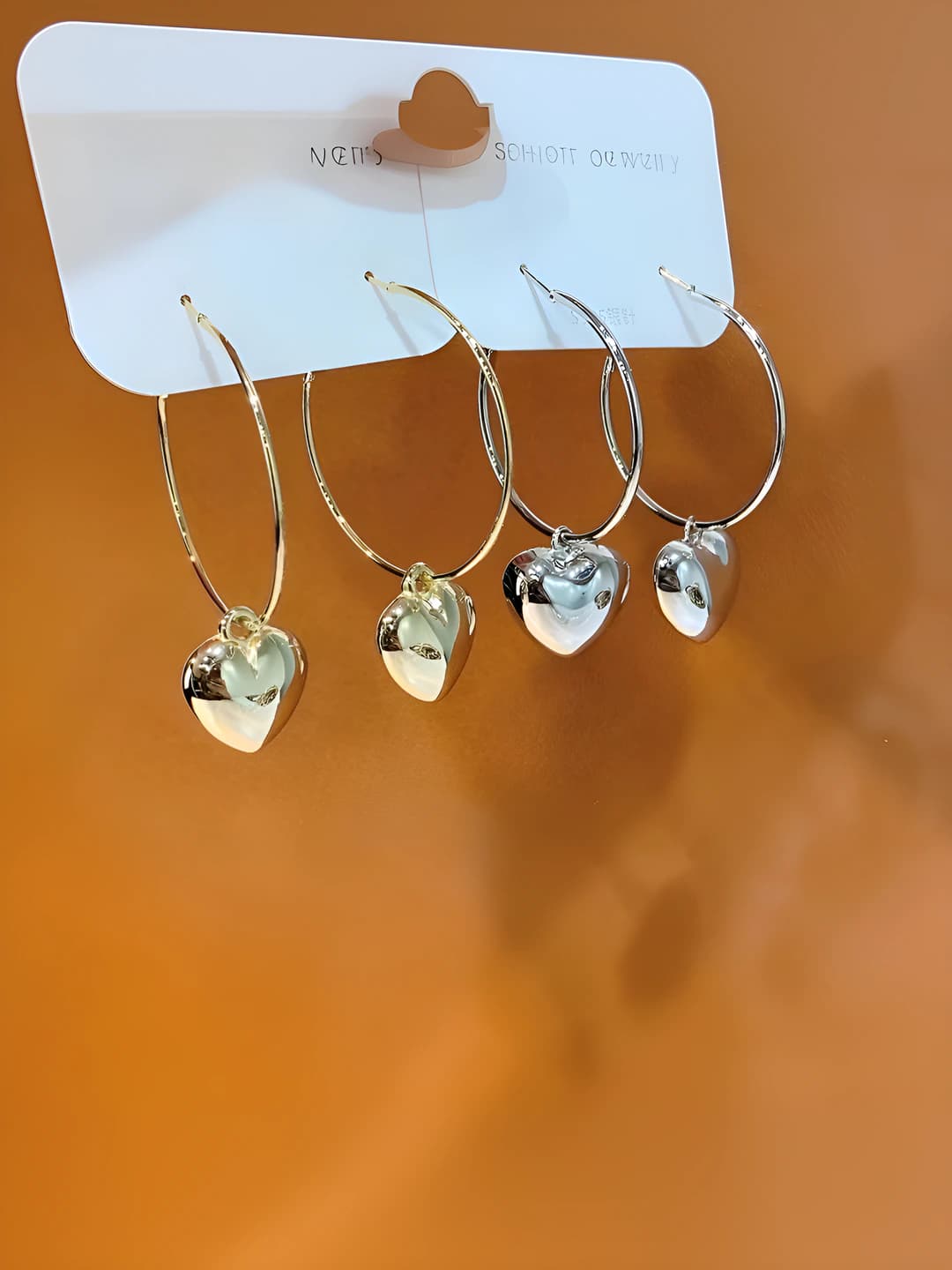 Women's hoop earrings with heart charms, simple modern style