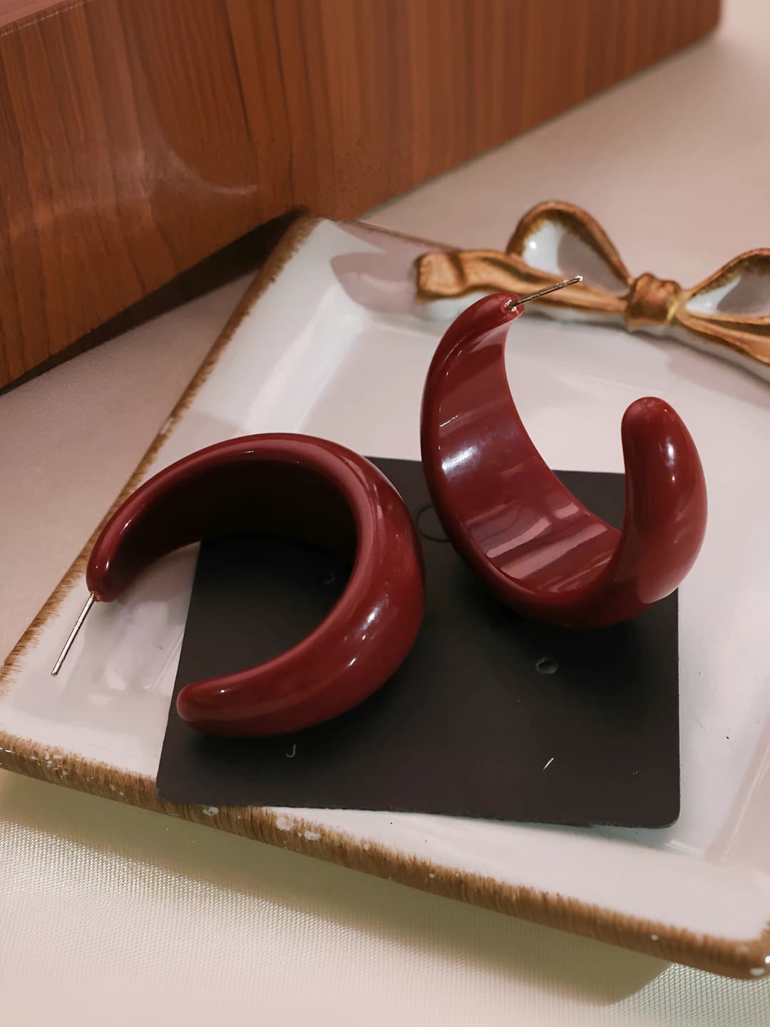 Red C-shaped studs