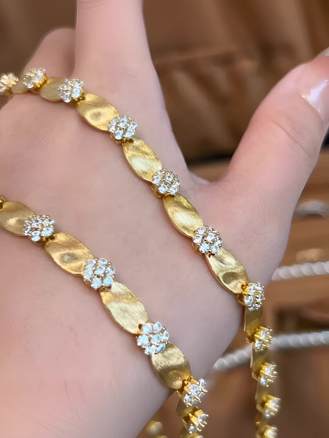Women's retro style gold bracelet with micro-set stones, floral pattern and geometric design element