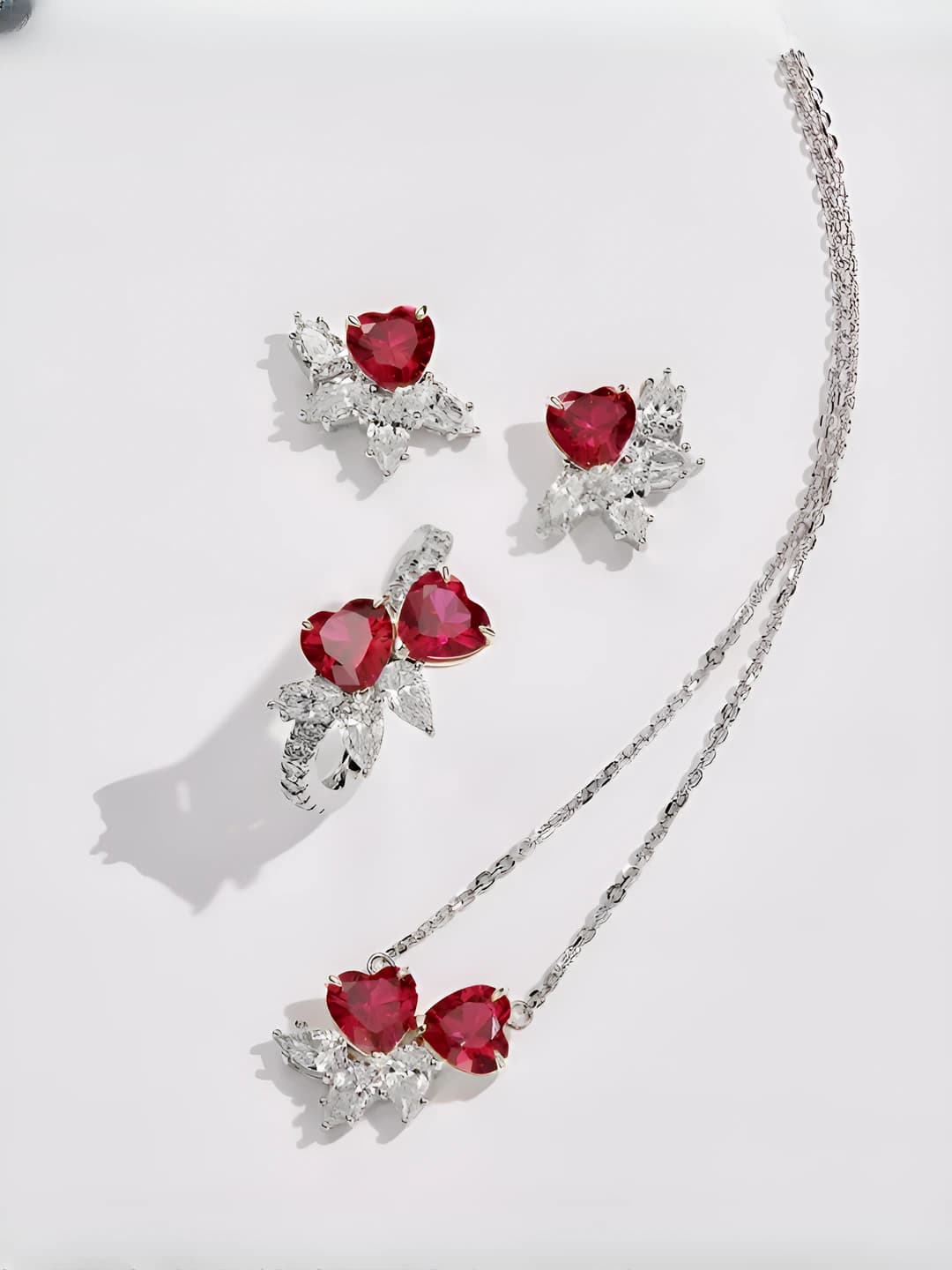 Women's retro jewelry set with ruby and diamond heart-shaped earrings, ring, and necklace