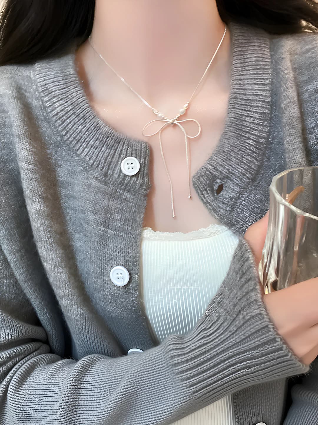 Silver bow pearl necklace