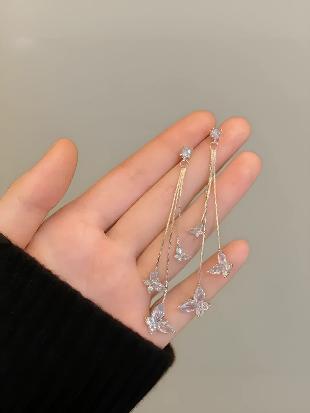 Women's long silver tassel dangle earrings with butterfly pendant