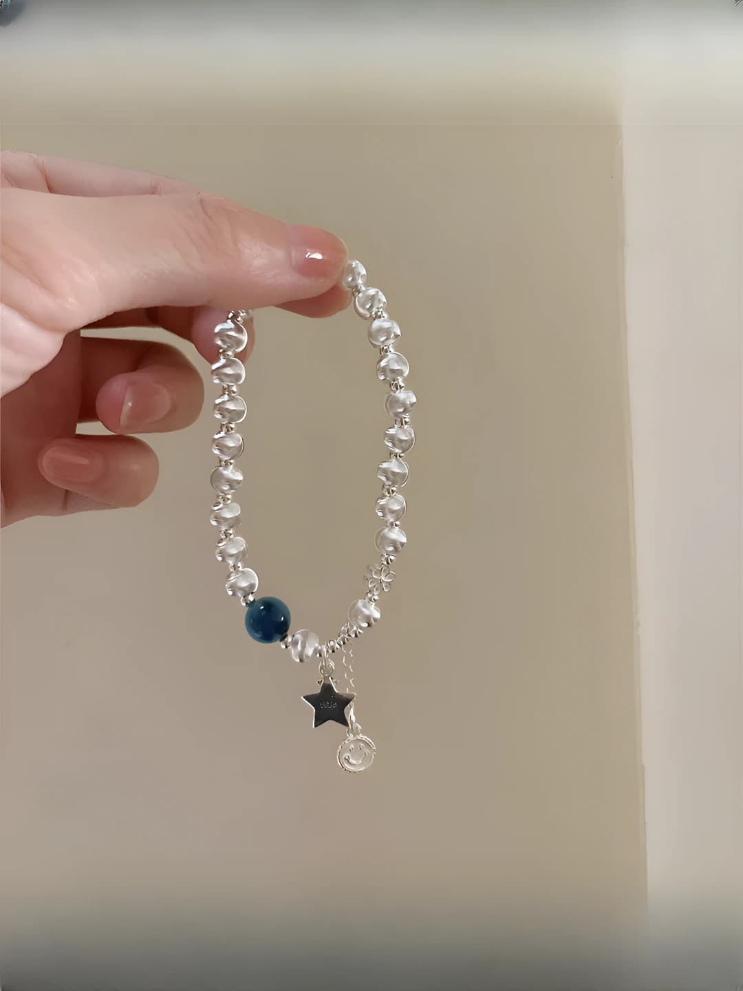 Women's beaded bracelet with stars and smiley faces on stretch cord