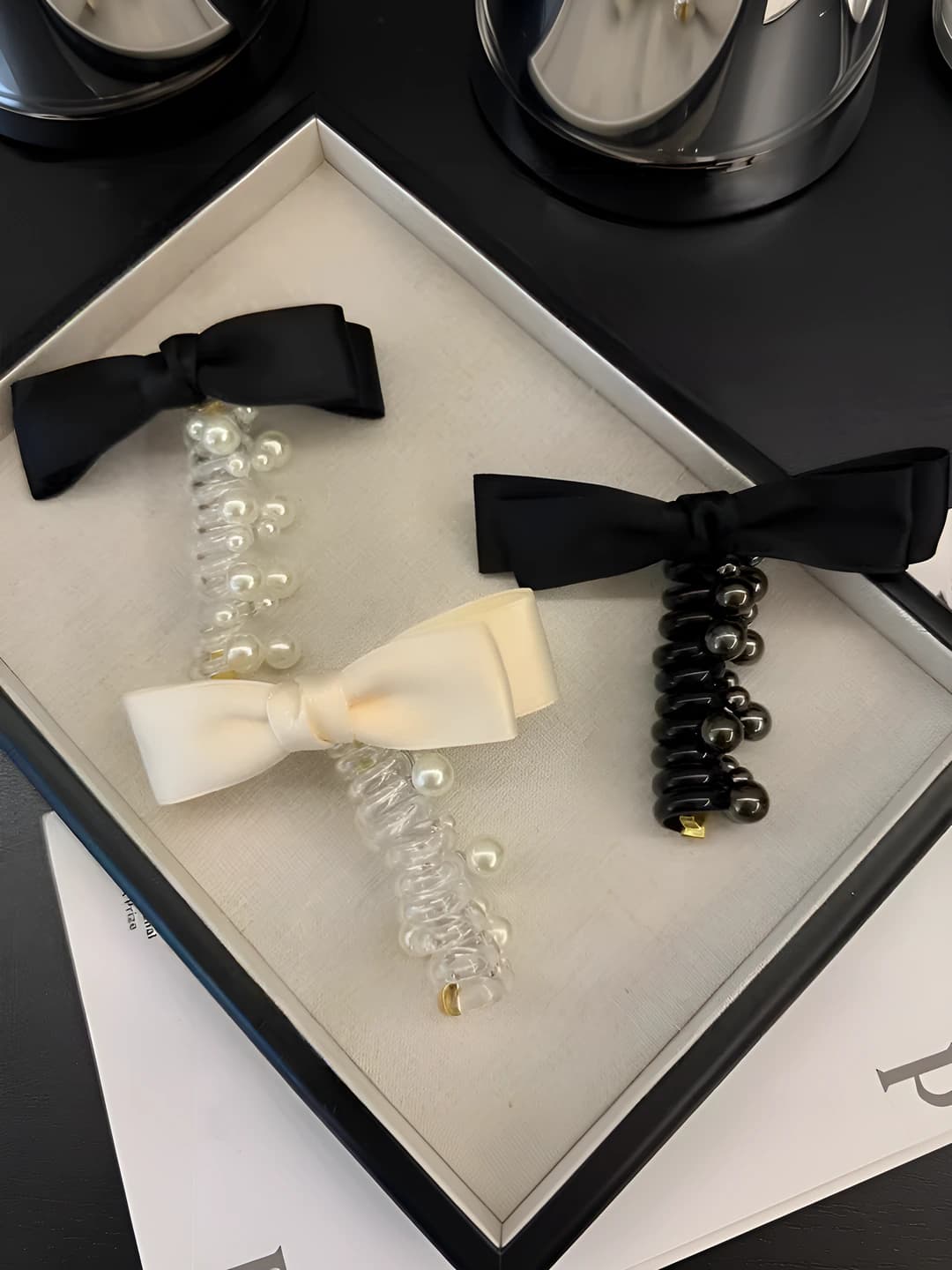Black, white beads, bow