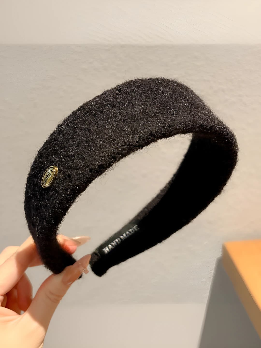 Black felt with gold logo