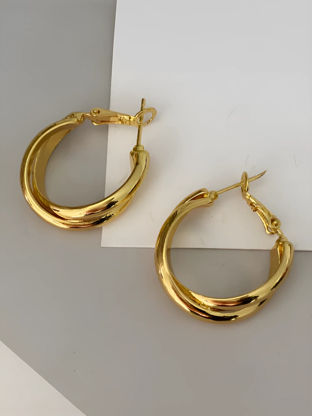 Gold crossed hoops