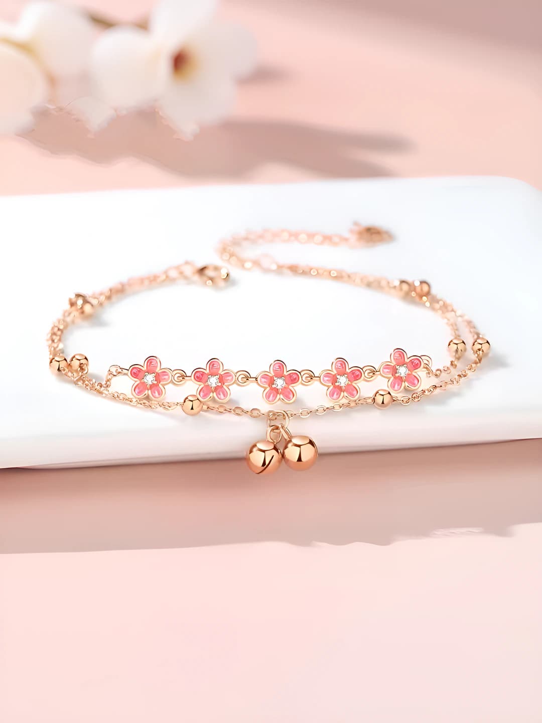 Women's pink anklet with bells and ribbon design