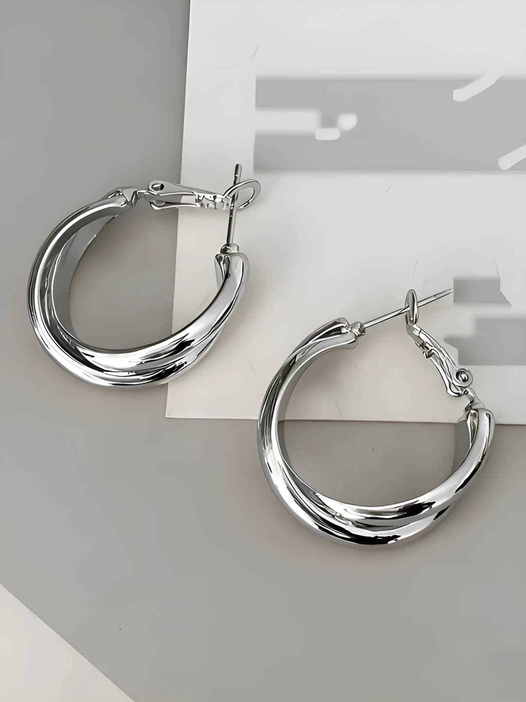 Silver crossed hoops
