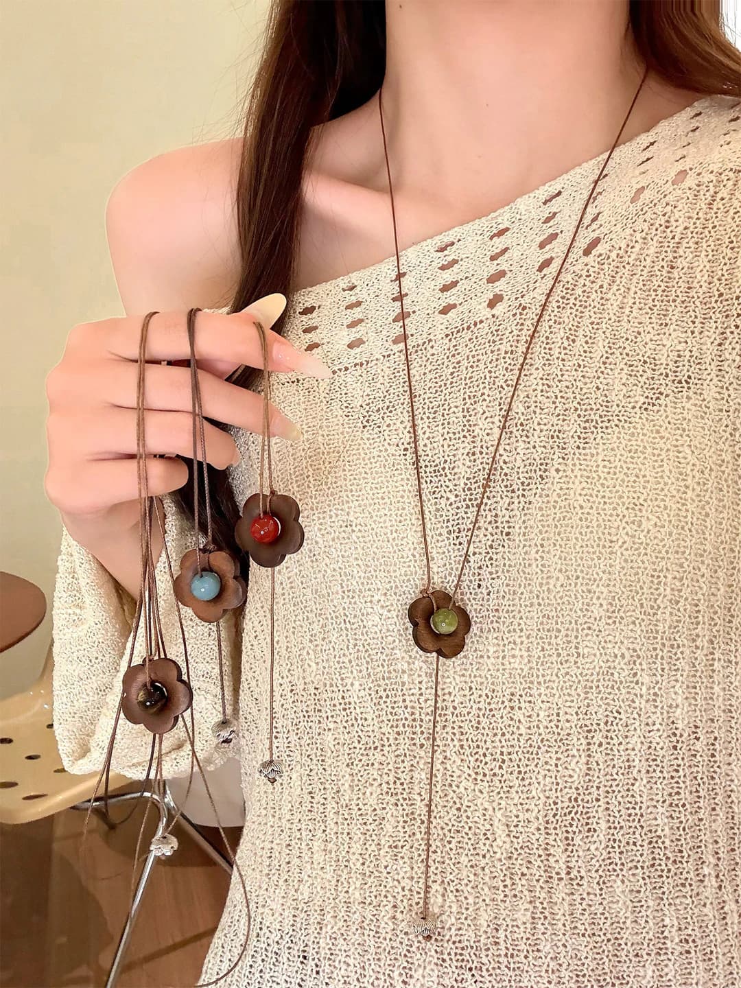 Women's long beaded necklace with wooden beads and floral design in retro style
