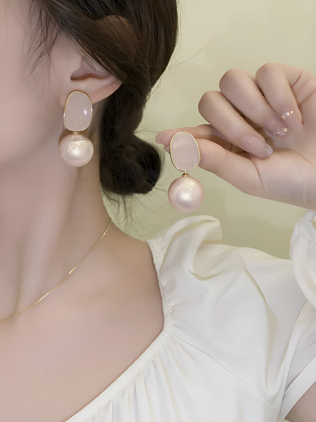Women's pearl drop earrings with silver posts in retro style