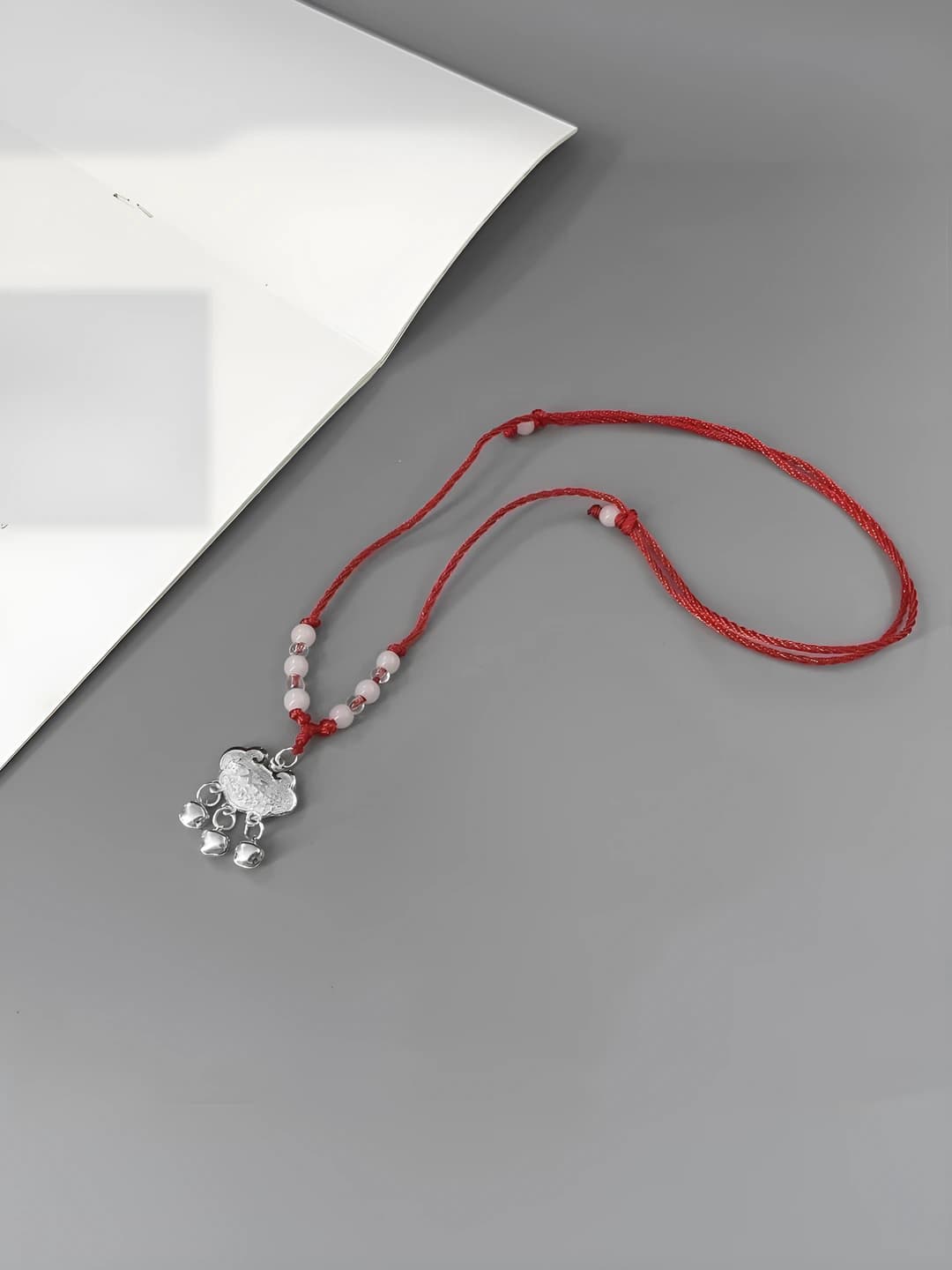 Silver, red cord