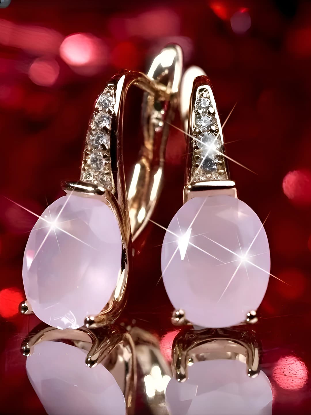 Women's pink oval copper earrings with gold teardrop design element