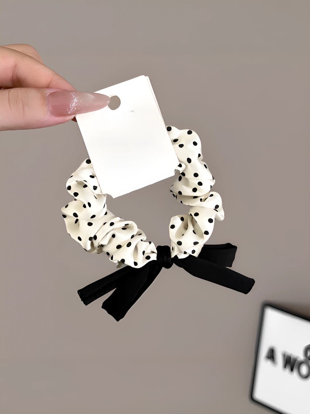 White polka dot hair tie