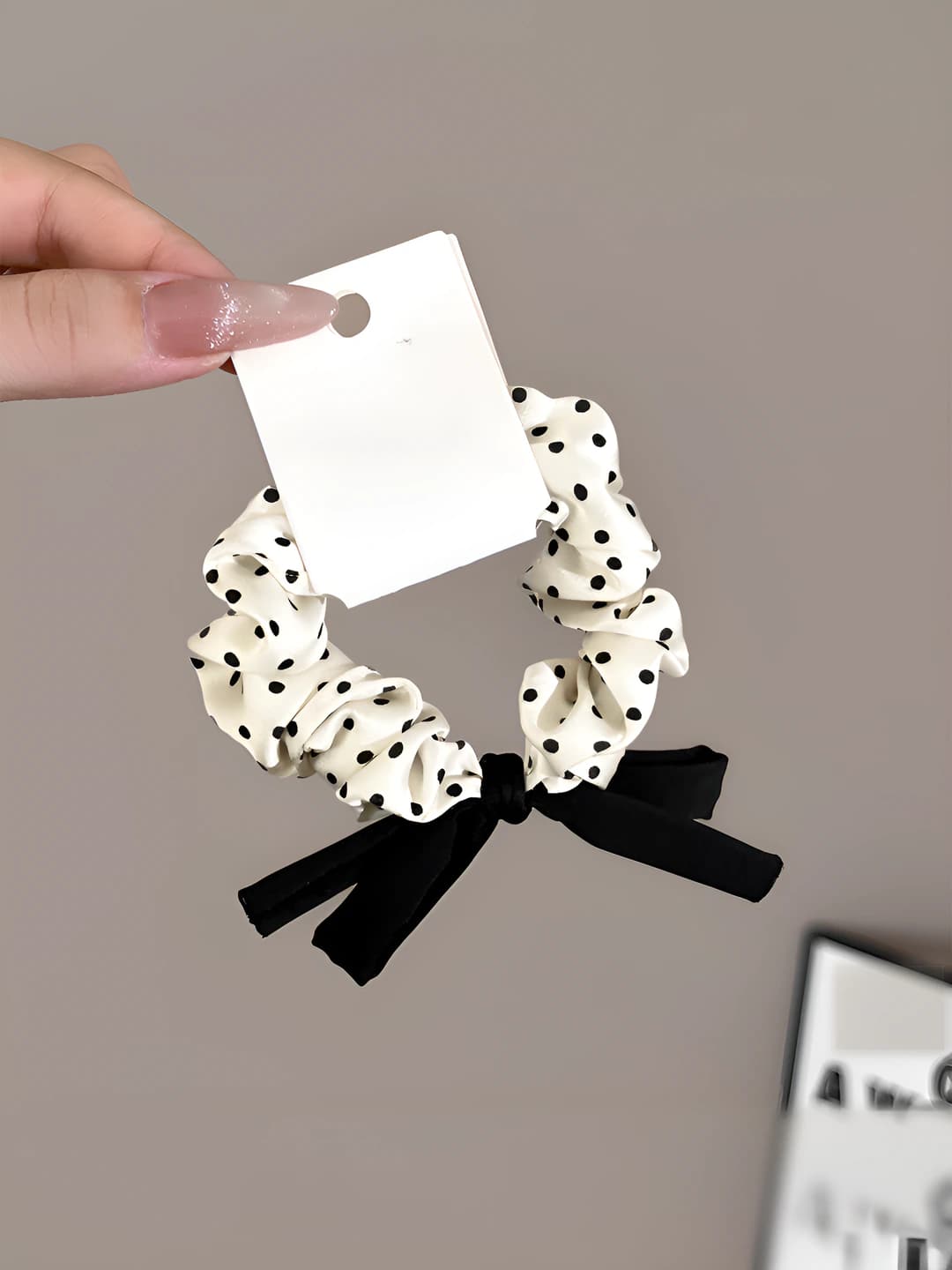 White polka dot hair tie