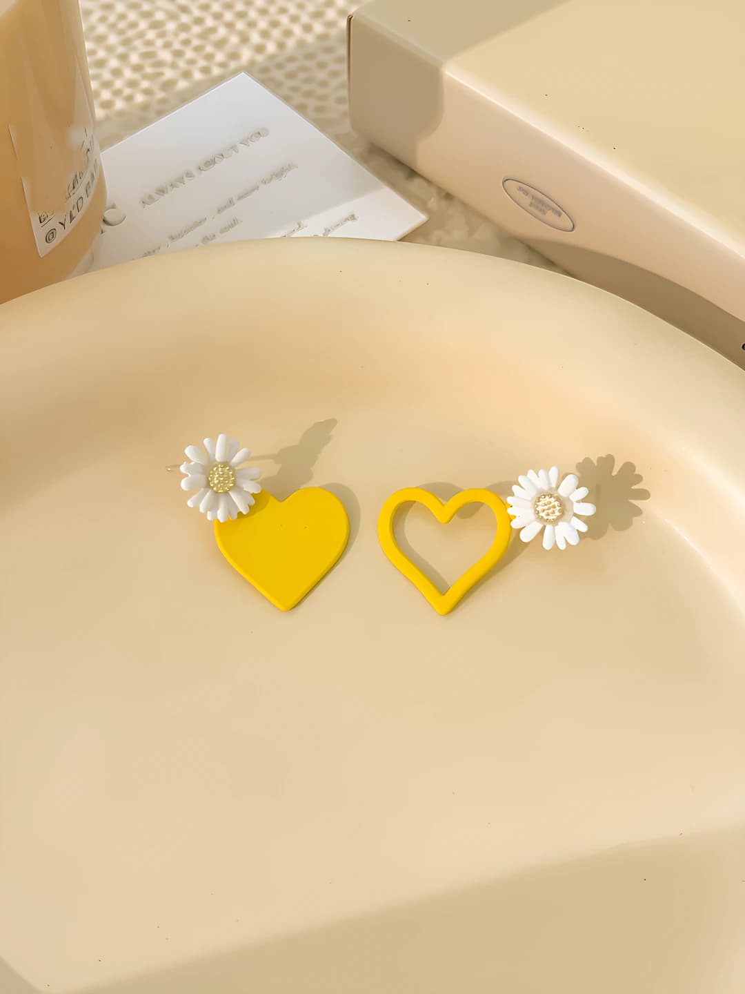 Asymmetric yellow heart stud earrings