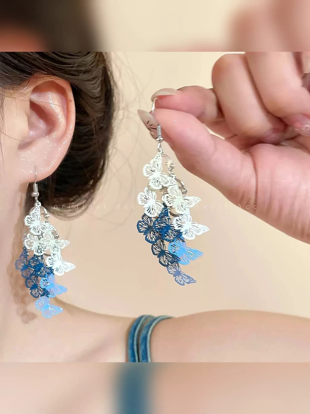 Silver-blue openwork butterfly earring