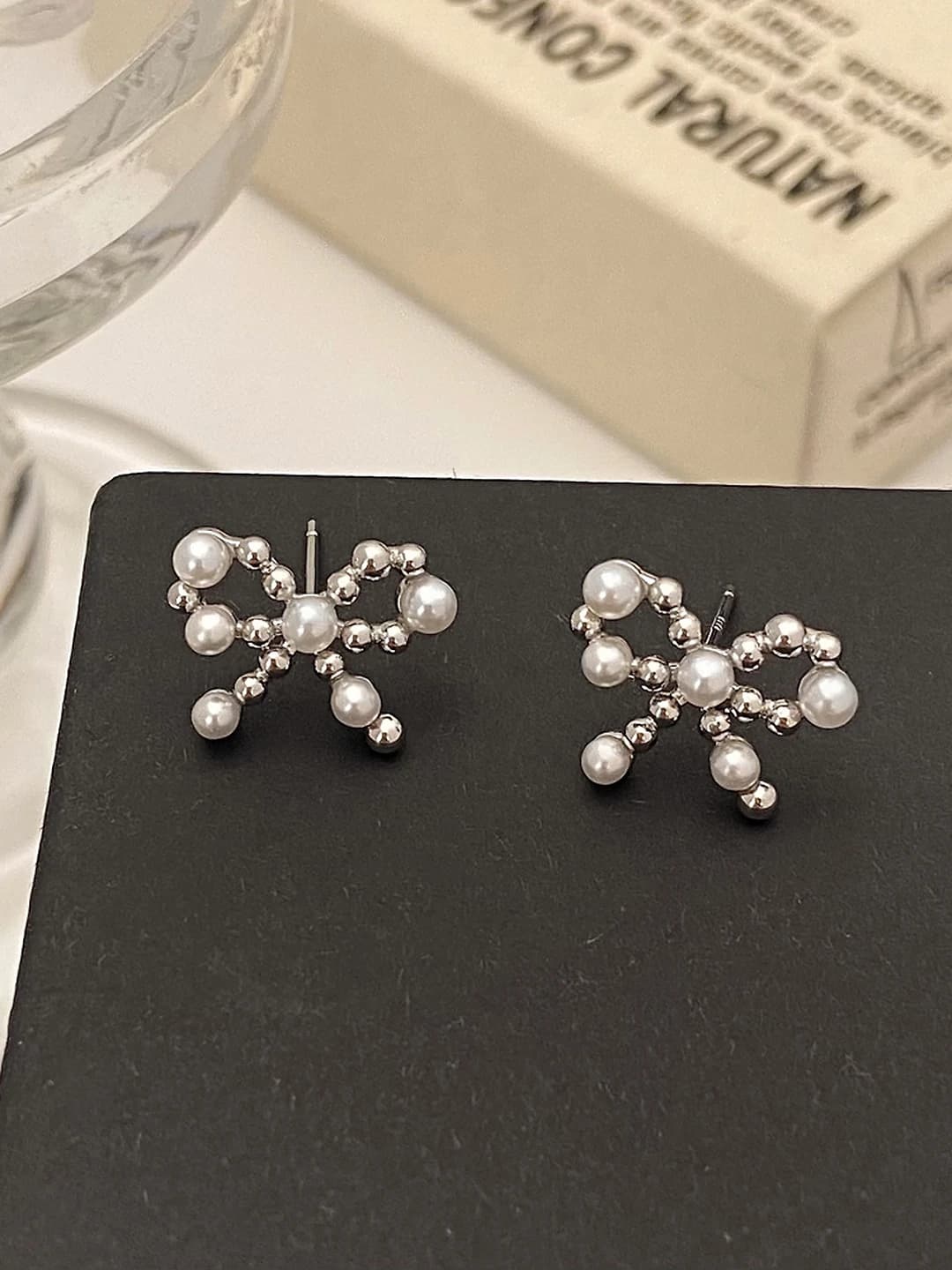 Silver bow pearl studs