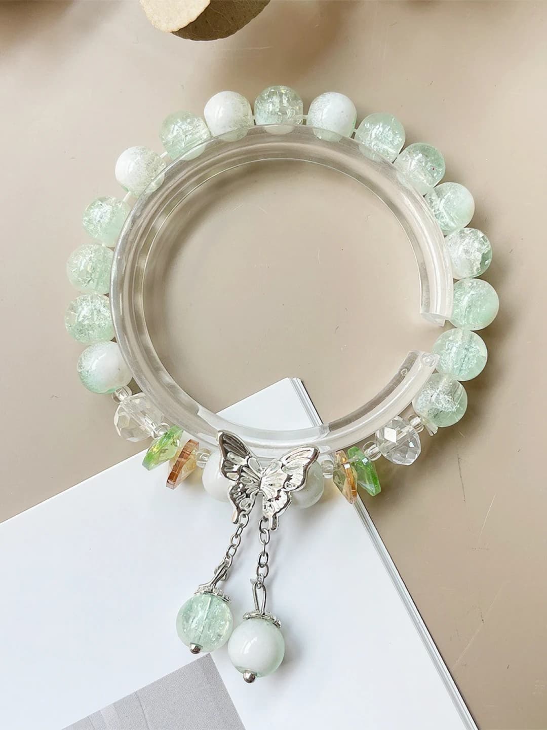 Green, cream top, tassel, butterfly