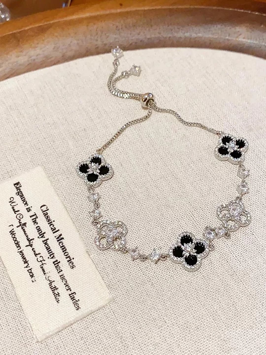 Silver bracelet with black flowers